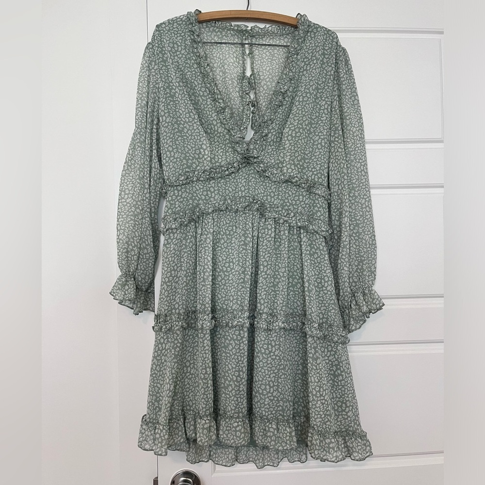 Large, open back mini dress in a green and white print
